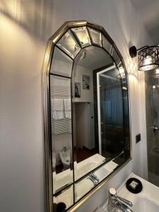 a bathroom with a large mirror over a sink at Calefati Gallery Luxury Apartment in Bari