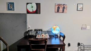 a room with a wooden table with a globe on it at Private Guest Suite in West Bellevue Home in Bellevue