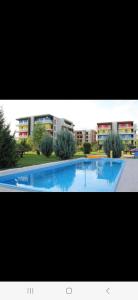 a large swimming pool in front of a building at Teo Airport Residences in Otopeni