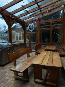 a wooden picnic table and benches on a patio at Penzion Quercus in Dubové