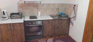 a small kitchen with a sink and a stove at Aura City 2 in Visoko