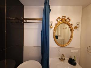 a bathroom with a mirror and a sink and a toilet at Luxury Penthouse with Large Terrace & Panoramic Old Town View in Vilnius
