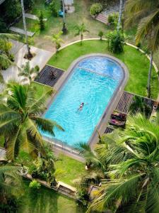 an overhead view of a pool with a person swimming in it at Hotel Riverrina in Negombo