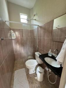a bathroom with a toilet and a sink at Pousada da Celma in Fortaleza