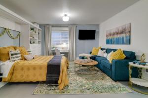 a bedroom with a bed and a blue couch at Modern Studio Oasis, WFH, Mins to Uni of Portland in Portland
