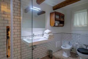 a bathroom with a sink and a toilet at La Casetta nel Cerchio in Ravenna +23 photos