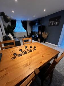 uma mesa de madeira com óculos na sala de estar em Ty Daisy, Gilwern em Gilwern