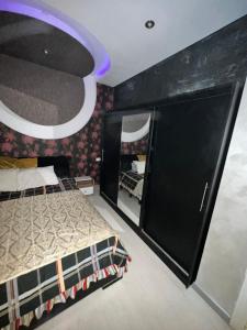 a bedroom with a bed and a mirror at Rawdat Zayed Compound in Sheikh Zayed