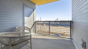 a balcony with two chairs and a view of the ocean at Landing Modern Apartment with Amazing Amenities (ID1401X866) in Denver