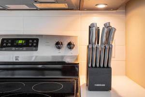 a kitchen with a knife block next to a stove at Landing Modern Apartment with Amazing Amenities (ID1148) in Arlington