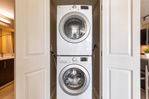 a washer and dryer in a kitchen next to a door at Landing Modern Apartment with Amazing Amenities (ID1148) in Arlington