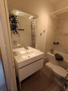 a white bathroom with a sink and a toilet at ch'ty breizh in Perros-Guirec +15 photos