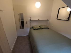 a small bedroom with a bed in the corner at ch'ty breizh in Perros-Guirec