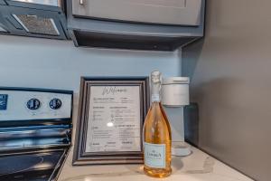 a bottle of wine sitting on top of a kitchen counter at 1 BR 1 BA Luxury - Museum District & Downtown HTX in Houston