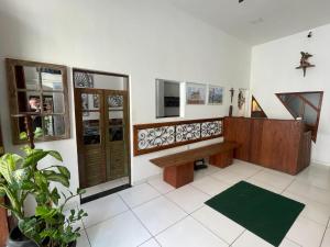 a living room with a bench and a staircase at Pousada Suítes Do Pelô in Salvador