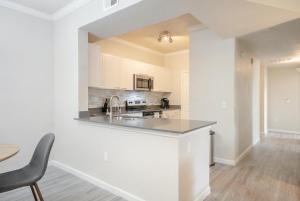 a white kitchen with a sink and a counter at Landing Modern Apartment with Amazing Amenities (ID4278) in Anthem