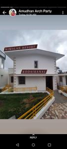 a white building with a sign on the side of it at Relaxzen Homestay 2 in Kodaikānāl