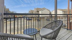 a balcony with two chairs and a table and a railing at Landing Modern Apartment with Amazing Amenities (ID7807X89) in Wichita