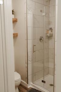 a bathroom with a glass shower with a toilet at Central Tacoma Triplex in Tacoma +14 photos