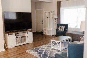 a living room with a large flat screen tv at Central Tacoma Triplex in Tacoma