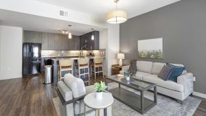 a living room with a couch and a table at Landing Modern Apartment with Amazing Amenities (ID6640) in Sandy