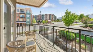 a balcony with two chairs and a view of a street at Landing Modern Apartment with Amazing Amenities (ID6640) in Sandy