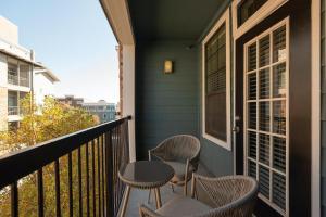 a porch with chairs and tables on a balcony at Landing Modern Apartment with Amazing Amenities (ID5843) in Austin