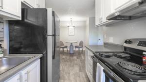 a kitchen with a stainless steel refrigerator and a table at Landing Modern Apartment with Amazing Amenities (ID9974X77) in Sparks