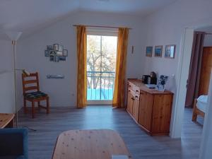 a living room with a table and a sliding glass door at Urlaubsoase Ostsee in Hohen Schönberg