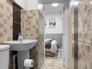 a bathroom with a sink and a shower at Stylish Studio Suite w/ VIP lounge access - Maerdy 