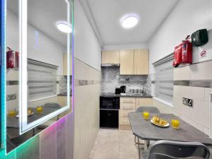 a kitchen with a table and some drinks on it at Stylish Studio Suite w/ VIP lounge access - Maerdy 