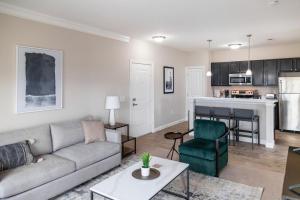 a living room with a couch and a kitchen at Landing Modern Apartment with Amazing Amenities (ID5458) in Lewis Center