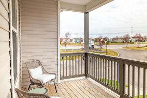 a balcony with a rocking chair and a view of a street at Landing Modern Apartment with Amazing Amenities (ID5458) in Lewis Center