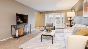 a living room with a white couch and a tv at Landing Modern Apartment with Amazing Amenities (ID8747X90) in Carmel