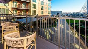 a balcony with two chairs and a table and a building at Landing Modern Apartment with Amazing Amenities (ID8426X91) in Tacoma