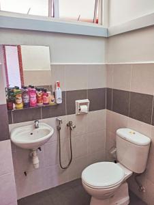 a bathroom with a toilet and a sink at Sky Palace Kuala Terengganu in Kuala Terengganu