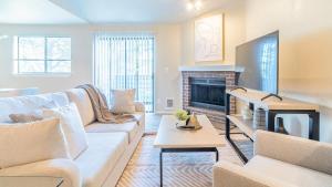 - un salon avec un canapé et une cheminée dans l'établissement Landing Modern Apartment with Amazing Amenities (ID8472X99), à Redmond