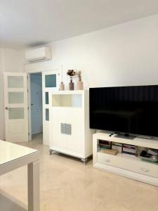 a living room with a large flat screen tv at Apartamento Espinel 47 in Ronda +4 photos