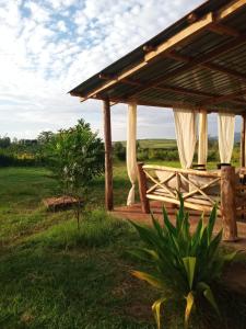 a wooden pavilion in the middle of a field at KIJIJI VILLAGE in Emali