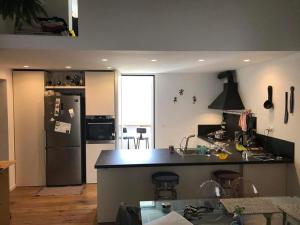 a kitchen with a black counter and a refrigerator at Casa Guido Eco Friendly in Lecce