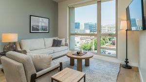 a living room with a couch and a table at Landing Modern Apartment with Amazing Amenities (ID6454X40) in Salt Lake City