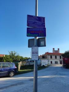 a street sign on a pole in a parking lot at LUX ARENA RESIDENCE EMA in Pula