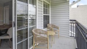 a patio with two chairs and a table on a balcony at Landing Modern Apartment with Amazing Amenities (ID7856X82) in Midlothian