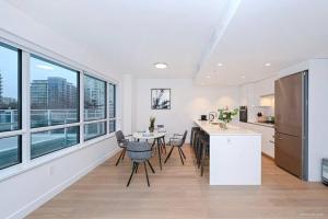 a kitchen and dining room with a table and chairs at new apartment 3 bedrooms in Richmond