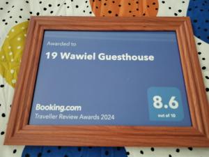 a wooden frame with a sign that reads wandfield guesthouse at 19 Wawiel Guesthouse in Orkney