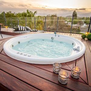 a jacuzzi tub on a deck with candles at La Sofia Apart & Wines in Mendoza