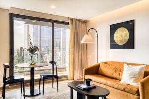 a living room with a couch and a table at ULIV Cibeles in Mexico City
