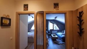 a room with two doors to a room with a bedroom at PinePino Borovets, aparthotel Borovets Gardens A60 in Borovets