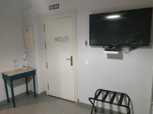 Televízia a/alebo spoločenská miestnosť v ubytovaní Patio de Arance