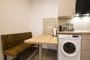 a kitchen with a table and a washing machine at Luxury Kirrberg in Homburg